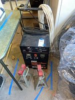 Front view of Solar 560 charger with two jack stands