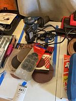 Black & Decker sander, Craftsman sander, Husky sanding discs on table