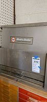Front of Black & Decker metal toolbox on top of plastic drawer unit