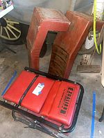 Two red ramps stood upright with creeper seat in front