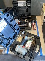 Both Porter-Cable tools in open cases with fasteners and manuals visible