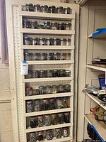 Full view of stacked jars filled with hardware