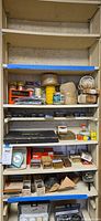Full shelving view showing ropes, hardware boxes, fastener organizer, packaged items