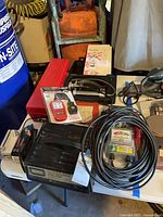 Table view showing charger, OBDII scanner, pressure tester kit, O-ring kit