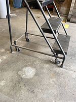 Side view of lower frame, casters and two lower steps