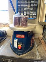 Front view of Ryobi spindle sander with sanding sleeves on top
