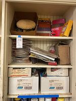 Three shelves of sanding discs, belts and packs