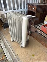 Full view of heater showing fins and caster wheels