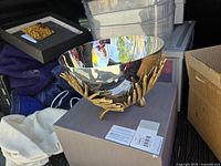 Bowl on gold branch base sitting on box lid