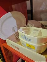 Stacked Blue Cornflower casseroles with glass lid and white platter