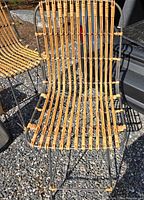 Front view of woven rattan chair on metal frame