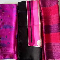 Three scarves side by side showing colours and patterns