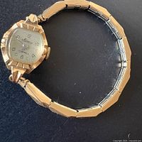 Front view of Mercury 14K watch showing dial, case, and expansion band