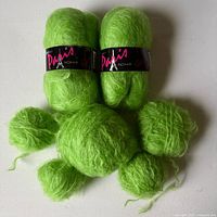 Two labeled skeins plus hand-wound balls of apple-green mohair yarn