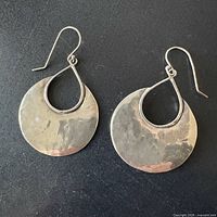 Front view of hammered sterling silver hoop earrings