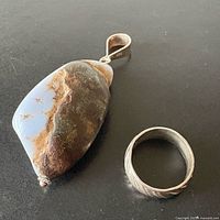 Pendant and ring side-by-side showing size and materials