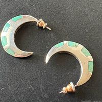 Both crescent earrings front view showing turquoise inlay and posts