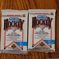Front view of two sealed 1991-92 Upper Deck NHL hockey card packs
