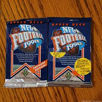 Front view of two sealed 1991 Upper Deck NFL Football packs showing graphics and labels