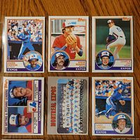 Fronts of six of the nine 1983 Topps Expos cards displayed on wood surface