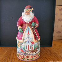 Front view of Jim Shore Santa figurine showing church scene and text