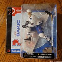 Front view of sealed Joe Sakic action figure in packaging