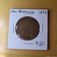 Reverse view in holder showing sailing ship design and legends.