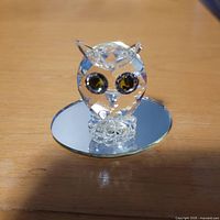 Front view of Swarovski clear crystal owl on mirrored base