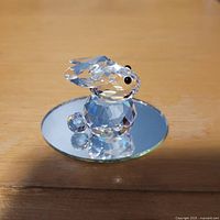 Side view of faceted crystal bunny on mirror base