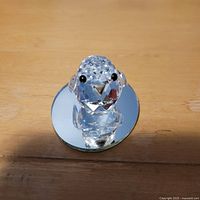 Front view of crystal bird on mirror base