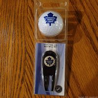 Front of sealed blister pack showing golf ball and divot tool with Toronto Maple Leafs logos