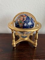 Front view of globe on brass stand