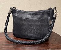 Front view of black Brighton Barbados Ziptop Hobo showing braided strap, pebbled leather and hardware