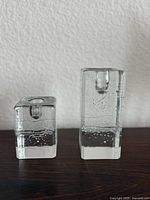 Front view of both square clear glass candle holders, short and tall sizes
