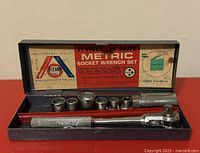 Closed-up view of open case showing ratchet, extension and seven sockets