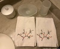 Lot overview showing two embroidered hand towels, frosted jar with lid, oval soap dish and tumbler