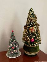 Both tabletop Christmas trees side by side