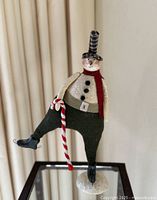Full view of snowman standing on glass table