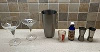 Entire set including two glasses, shaker tin, measuring cup, blue bottle, two jiggers