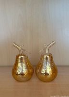 Front view of both gold-leaf glass pears