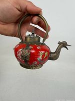 Full view teapot showing duck spout, handle, lid