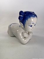 Front three-quarter view showing child figure, glaze condition and decoration