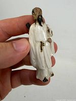 front view of porcelain bearded swordsman figurine