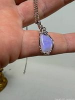 Front view of wire-wrapped opal pendant on chain