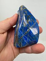 Front view of polished lapis lazuli showing deep blue color and pyrite inclusions