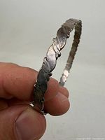 Side view of bracelet showing twisted leaf pattern