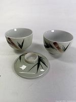 Two bowls and lid showing bamboo motif