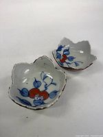 Pair of leaf-shaped Imari bowls showing interior decoration