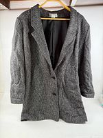 Full view of grey textured Forenza jacket on hanger