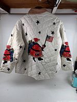 Full back view showing Santa appliqués, stars and quilting